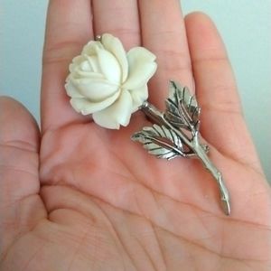White flower and silver toned brooch